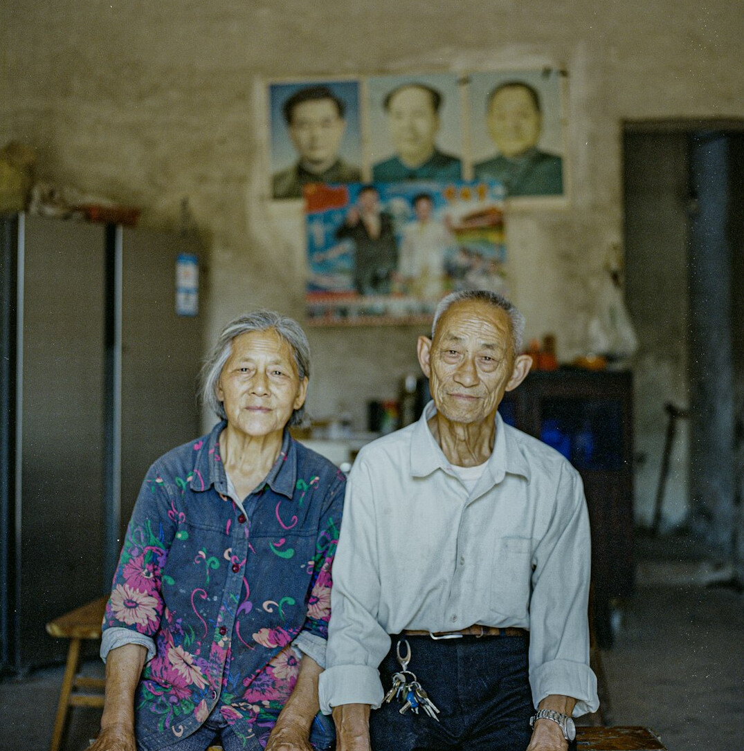 Mature Latin American couple talking about household expenses at a living room table
