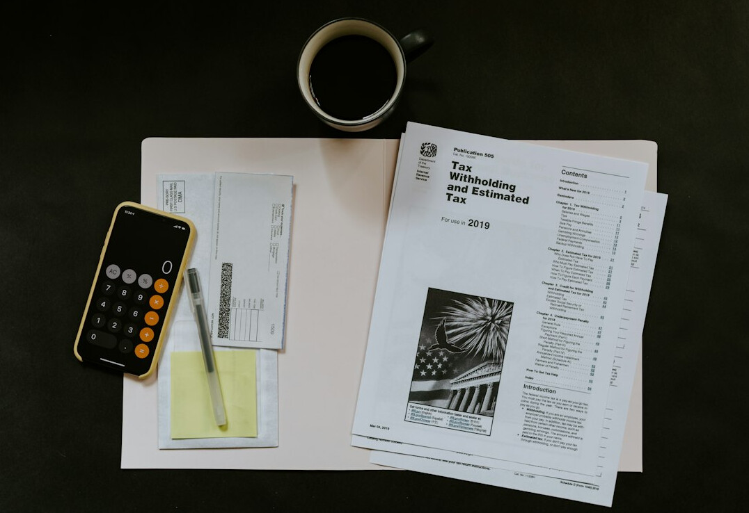person tracking expenses on paper