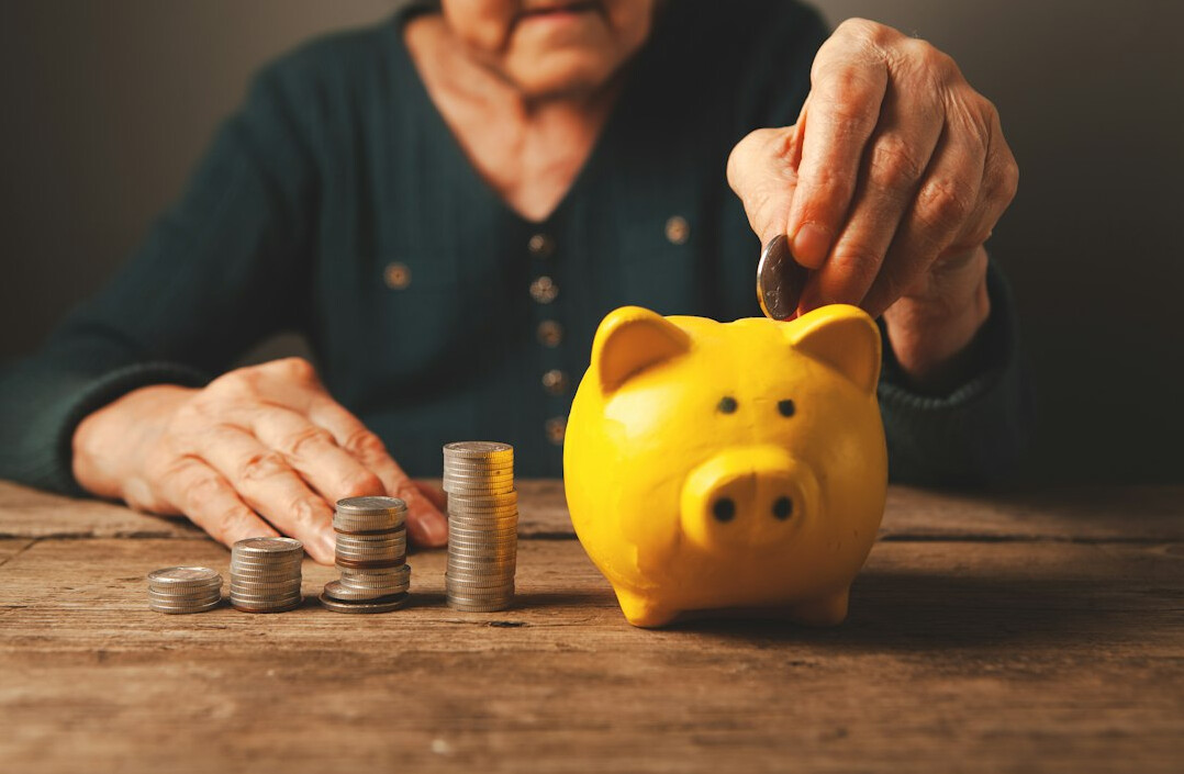woman saving money in piggy bank