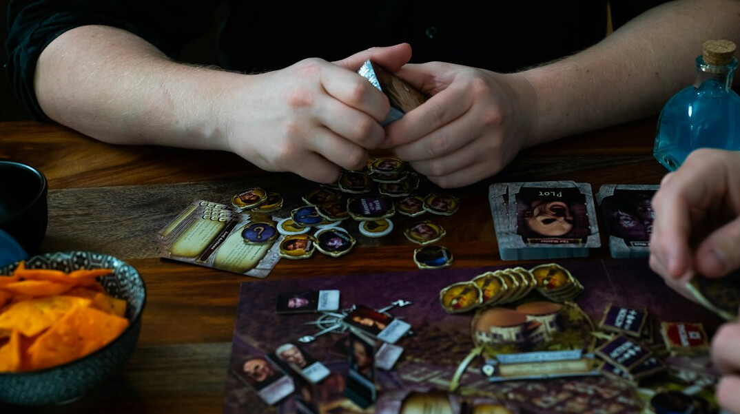 family playing board game at table